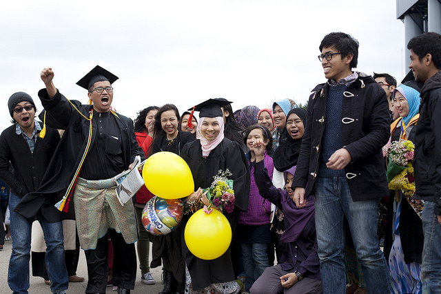 family gathers around graduate