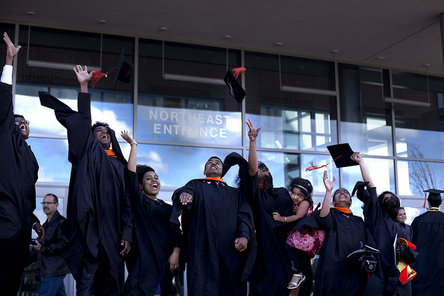 Group of students throwing their caps after CoE Graduation